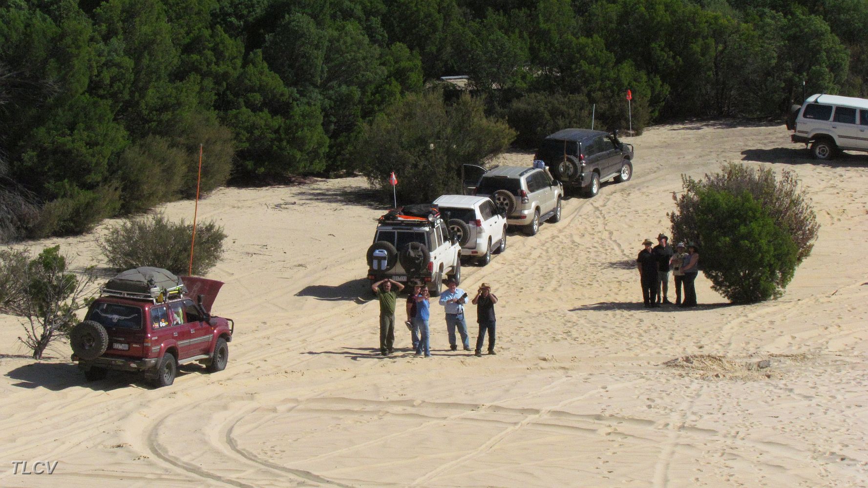 19-The rest of the convoy watch the next 4WD climb up the steep dune.JPG